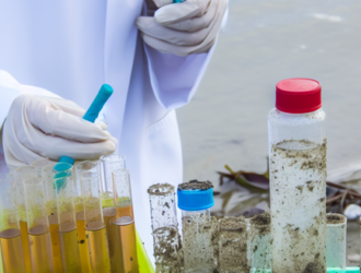 A collection of samples from a polluted water body by a female scientist