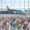 A large group of individuals at an airport terminal, showcasing extensive air travel