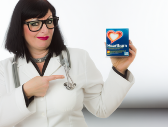 An image of a medical professional pointing at a Zantac box to illustrate the connection between Zantac and cancer claims