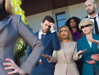 A group of victims standing outside a courthouse, showing signs of frustration