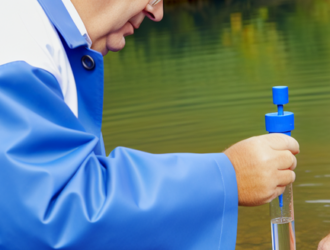 An inspector testing the water quality at a local river