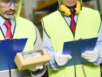 Inspectors examining products in a factory, ensuring they meet safety guidelines
